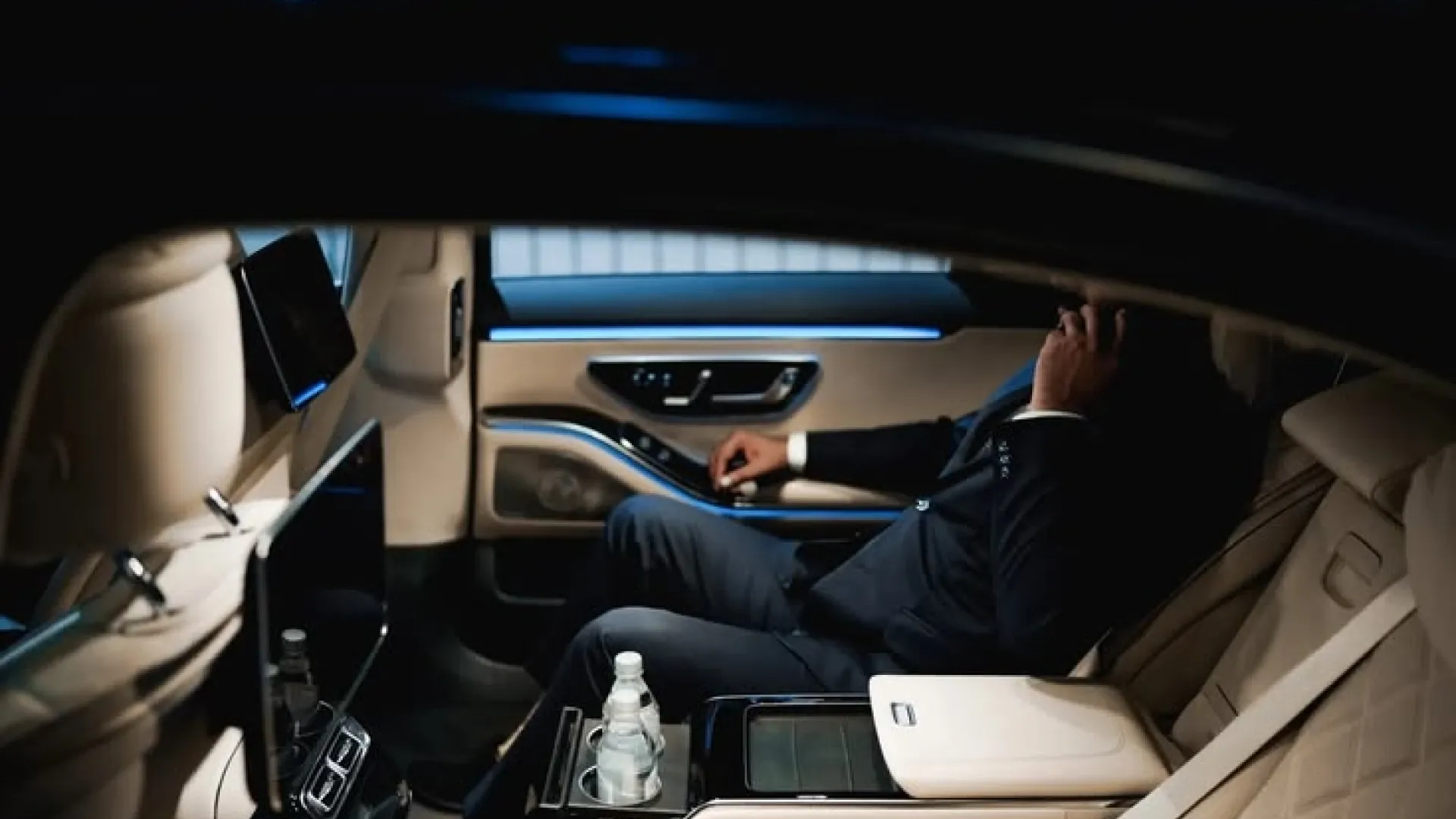 Passenger seated in the rear of a MIABA sedan